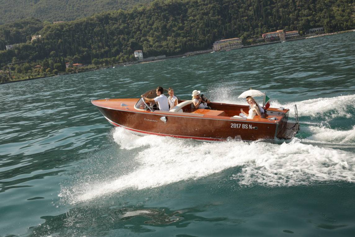 Bride and groom on a speedboat on Lake Garda