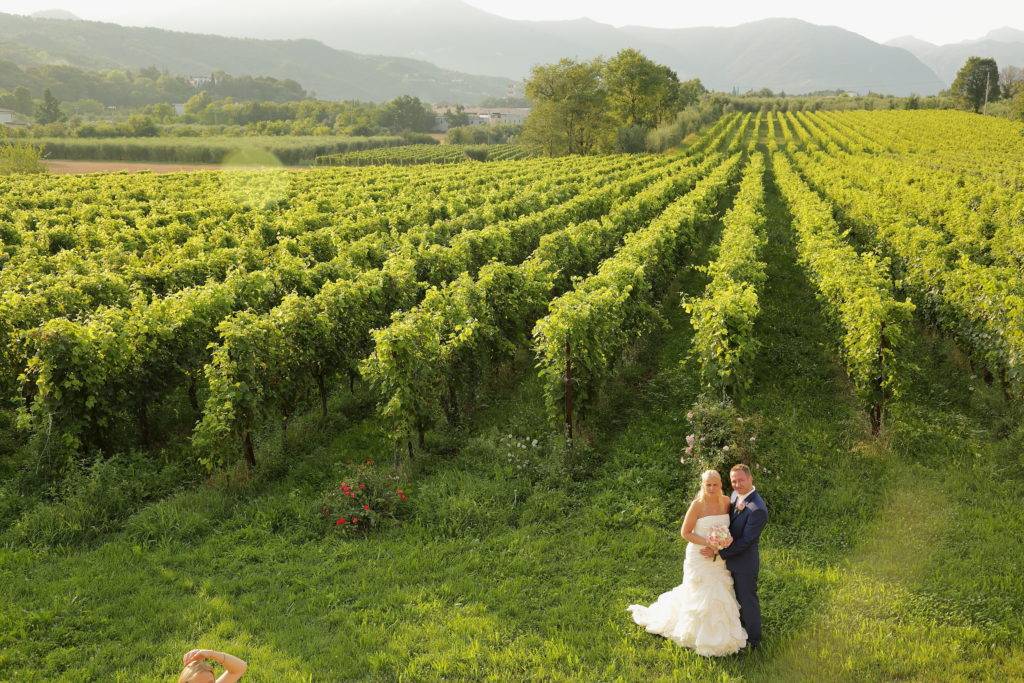 Bride and groom in front of a vineyard